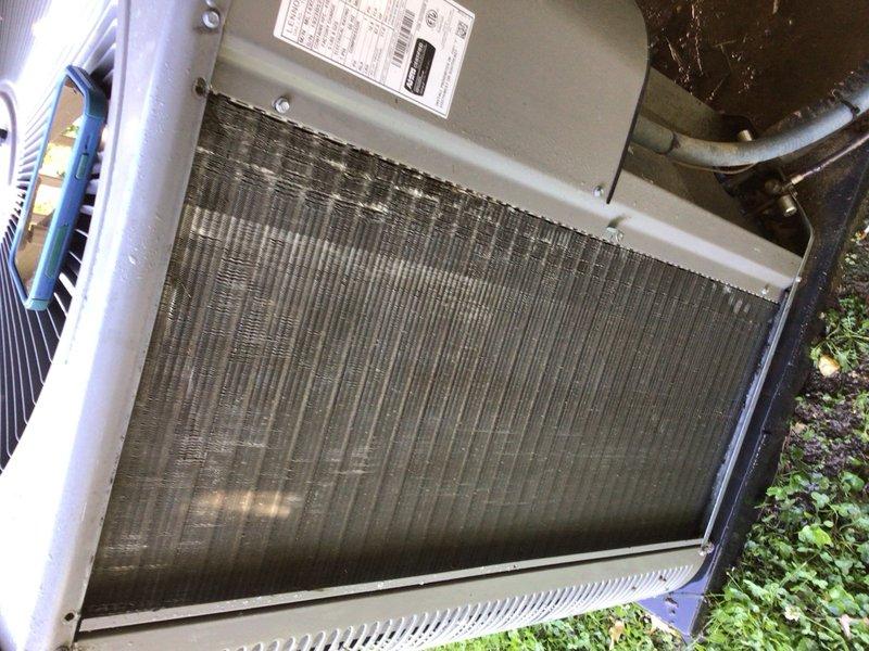 Completed preventative maintenance tune-up on single outdoor AC unit as part of Home Depot service agreement. Upon arrival, found condenser coil heavily soiled with accumulated dust, dirt, and debris buildup that was significantly restricting airflow through the fins. Performed thorough cleaning of condenser coil to remove matted debris and restore proper airflow capacity. Inspected compressor housing and all visible components for proper operation. Unit returned to normal operating efficiency following coil cleaning and standard tune-up procedures.