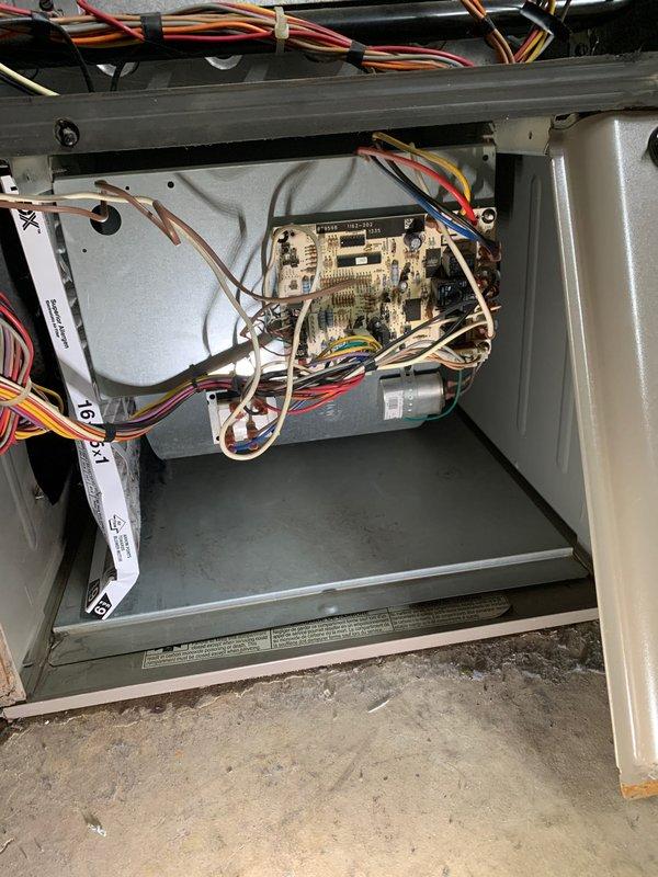 Completed seasonal tune-up and safety inspection on 50-year-old residential HVAC system located at side of house. Performed comprehensive maintenance including visual inspection of control board, electrical connections, and wiring harnesses; verified all wire bundles were properly secured with cable ties and routed correctly throughout cabinet; checked capacitor condition and mounting; inspected ignition module and control components for proper operation; examined copper refrigerant lines for damage or wear; confirmed all safety controls and electrical connections were secure and functioning within manufacturer specifications. Unit tested and left in proper working order with no deficiencies noted; all components clean and well-maintained with organized wiring and no visible signs of deterioration.