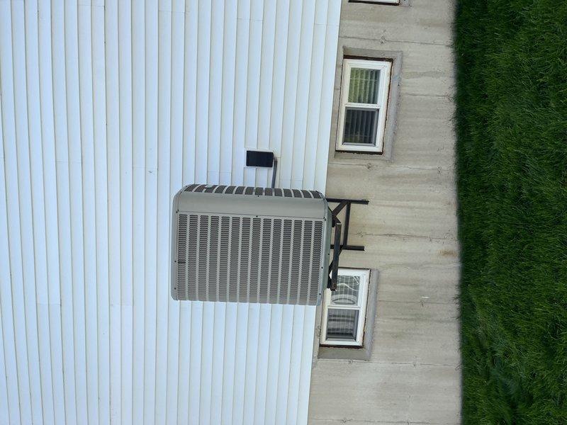 Responded to service call for water leakage near evaporator coils on 13-year-old residential air conditioning system. Upon arrival, inspected wall-mounted condensing unit and traced condensate drainage system through basement mechanical room. Located source of water leakage at evaporator coil drain pan and condensate line connections. Cleared blockage in condensate drain line, verified proper drainage flow, and confirmed drain pan integrity. Inspected air handler, ductwork connections, and associated PVC condensate piping for additional issues. System tested and cycled to ensure proper condensate removal with no further leakage detected.