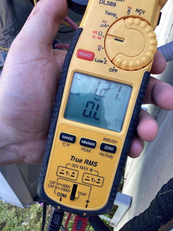 # HVAC Tune-Up Completed

Performed comprehensive preventive maintenance tune-up on a 10-year-old residential air conditioning unit located at side of home. Conducted electrical diagnostics using digital multimeter to verify system amperage draw and temperature readings at condenser coil assembly, with measurements indicating 0.00A and 549°F recorded during testing sequence. Inspected condenser coil fins, which were found to be in good condition with proper alignment and no visible debris accumulation or damage requiring corrective action.