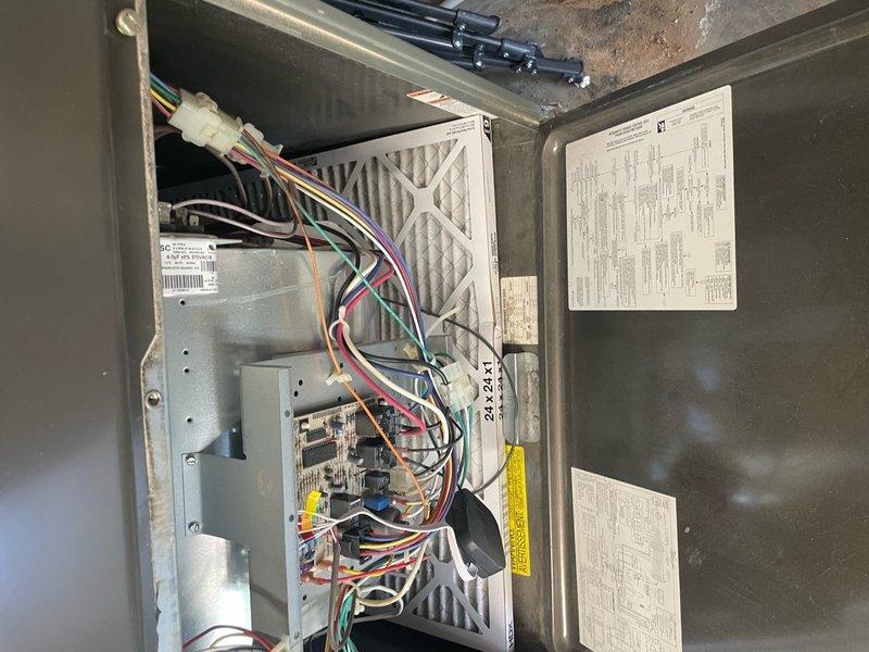 Performed comprehensive HVAC tune-up maintenance on residential heating and cooling system. Inspected electrical control panel, verified proper wiring connections and control board operation, and examined air filtration components. Evaluated outdoor condenser unit and noted moderate dust and debris accumulation on cooling fins, which is typical for units 8-12 years of age. All system components were assessed for proper operation and the unit was found to be functioning within normal parameters.