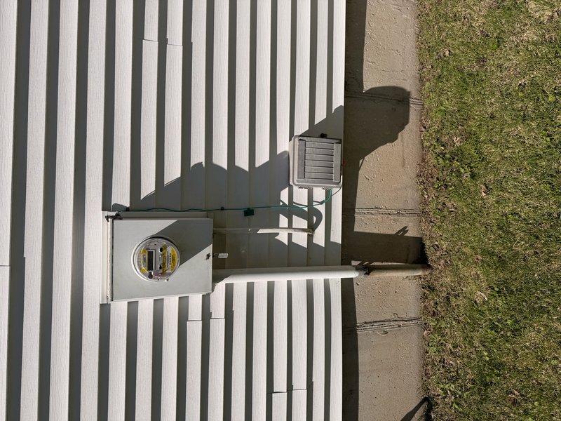 Responded to service call for electric vehicle charging station estimate. Assessed existing electrical service panel and meter configuration mounted on exterior wall, evaluated garage interior space for potential charger installation location, and documented current electrical infrastructure. Provided customer with comprehensive quote for EV charger installation based on site conditions and electrical capacity requirements.