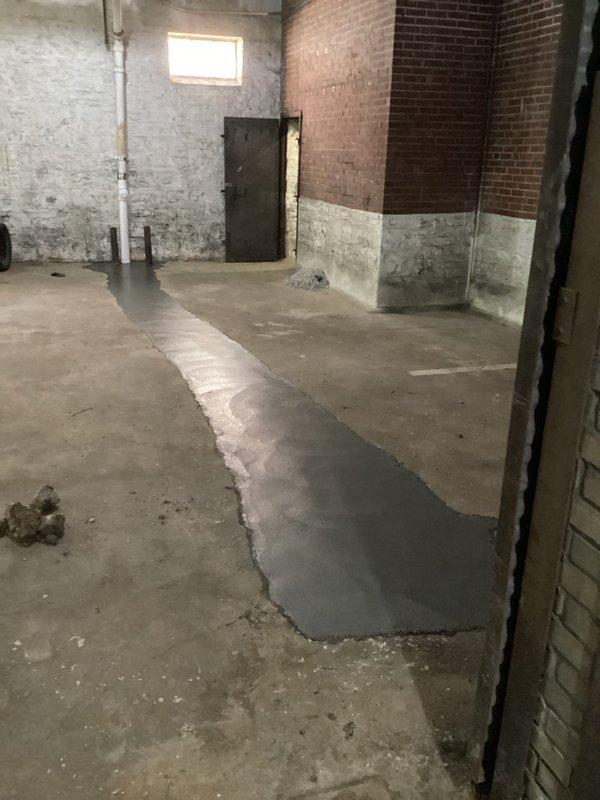 Completed commercial plumbing piping installation in basement facility, installing copper manifold system with multiple branch lines and isolation valves along exposed brick wall. Coordinated new piping with existing ductwork and performed concrete floor patching to conceal underground piping runs, ensuring proper system functionality and code compliance.