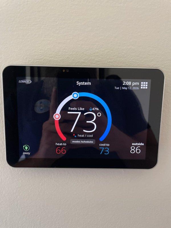 Completed scheduled cooling maintenance on a 9-year-old Lennox AC system. Performed comprehensive AC tune-up including refrigerant pressure testing using manifold gauges, which showed normal operating pressures. Verified Lennox smart thermostat operation displaying 73°F indoor temperature with system cooling to setpoint of 73°F and heating setpoint at 66°F. System confirmed operational and running efficiently with no deficiencies noted.