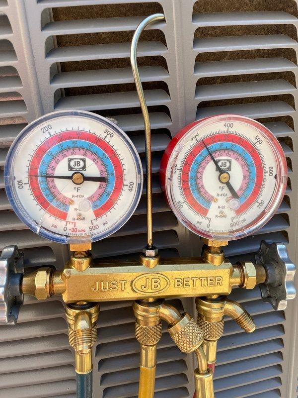 Completed scheduled cooling maintenance on a 9-year-old Lennox AC system. Performed comprehensive AC tune-up including refrigerant pressure testing using manifold gauges, which showed normal operating pressures. Verified Lennox smart thermostat operation displaying 73°F indoor temperature with system cooling to setpoint of 73°F and heating setpoint at 66°F. System confirmed operational and running efficiently with no deficiencies noted.