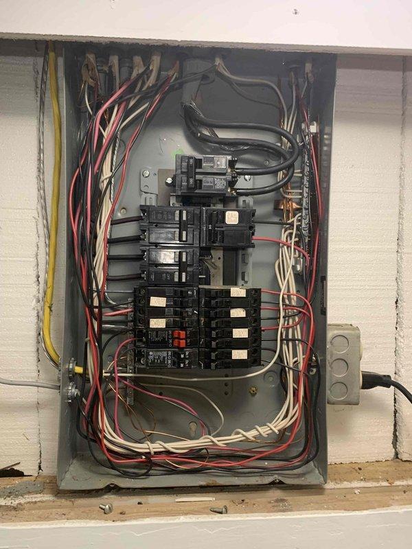 Responded to electrical emergency where plugging a microwave into one receptacle caused sparking at a different outlet, indicating a potential circuit fault or wiring issue. Performed comprehensive electrical panel inspection, documented breaker configuration and wiring conditions, and assessed circuit integrity to identify the source of the hazardous sparking condition.