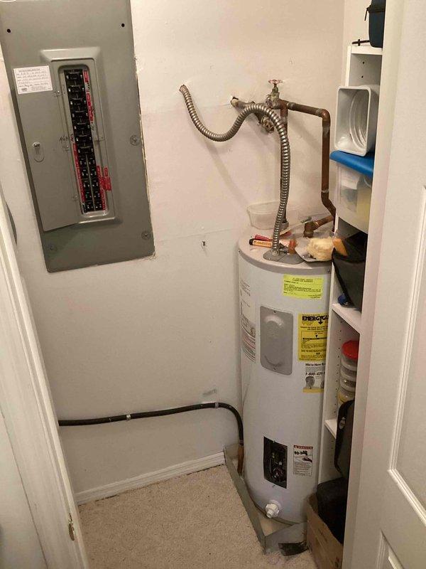 Responded to a no hot water condition in a condominium utility closet and successfully installed a 40-gallon electric tall water heater with GE SmartWater™ branding featuring a 6-year limited warranty. Installation included two 3/4" ProPress ball valves for water supply connections, copper piping with appropriate fittings, and a metallic flexible corrugated connector at the top of the unit. All work was completed in accordance with permit #26PLU-09415, with proper plumbing identification sticker applied as required. The unit was installed in a compact utility closet space adjacent to the electrical panel, with all connections properly secured and tested for leaks. The water heater was energized, filled, and verified operational before departure, restoring hot water service to the property.