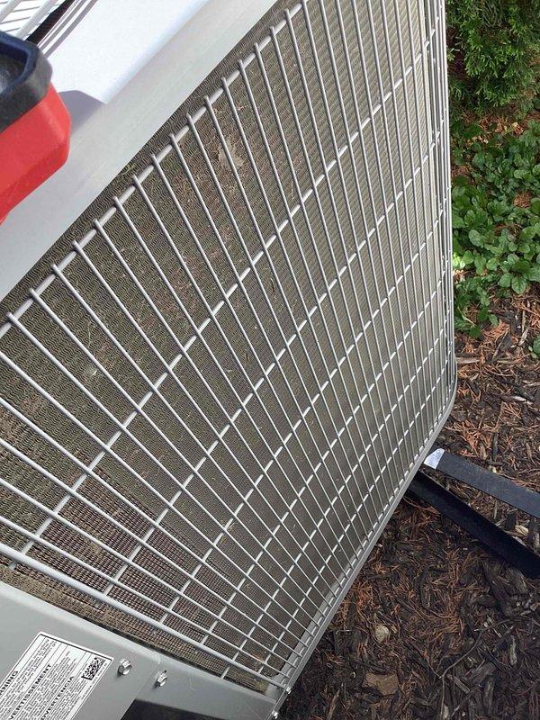 Completed comprehensive cooling system tune-up on outdoor condenser unit over 10 years old located in side yard. Performed standard maintenance protocol including inspection of condenser coils, grille assembly, and exterior housing—all components found to be in good working condition with no visible damage, debris accumulation, or deterioration. Unit operational and ready for continued service.