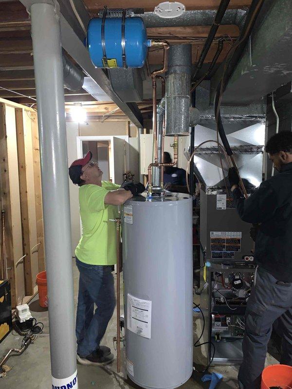 # Tanked Water Heater Installation

Successfully completed installation of a new residential tanked water heater in basement utility area. Removed existing unit and installed replacement water heater with proper plumbing connections, including copper supply lines, shut-off valves, and temperature and pressure relief valve piping. Installed expansion tank to accommodate thermal expansion in closed plumbing system. Connected all hot and cold water distribution lines with appropriate fittings and unions for future serviceability. Verified all connections for proper seal and tested system for leaks. Ensured adequate clearance from adjacent HVAC equipment and combustibles per manufacturer specifications and local code requirements. System was filled, purged of air, and brought to operating temperature. Verified proper operation of all safety devices and control systems. Installation completed in compliance with applicable plumbing codes. No permit or inspection sticker required per City of 