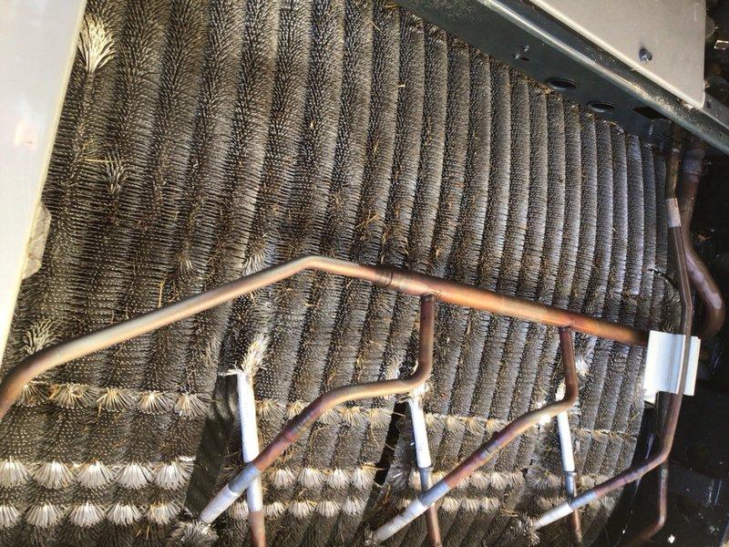 # HVAC Cooling System Tune-Up - Single Unit

## Work Performed

Completed comprehensive preventive maintenance service on residential air conditioning unit located in backyard. Upon initial inspection, discovered evaporator coil assembly heavily contaminated with accumulated dirt, dust, and debris, exhibiting dark matted buildup that significantly restricted airflow and heat transfer efficiency.

Removed top access panel to access internal components. Thoroughly cleaned evaporator coil fins using appropriate cleaning solutions and techniques to restore proper airflow. Addressed heavy contamination on coil surfaces that had accumulated over extended period without maintenance. Cleaned copper refrigerant lines and verified proper mounting bracket security along tube routing.

Inspected all accessible components including:
- Evaporator coil fin condition and cleanliness
- Copper refrigerant tubing for signs of wear or damage
- Mounting clips and brackets for secure positioning
- Unit hous
