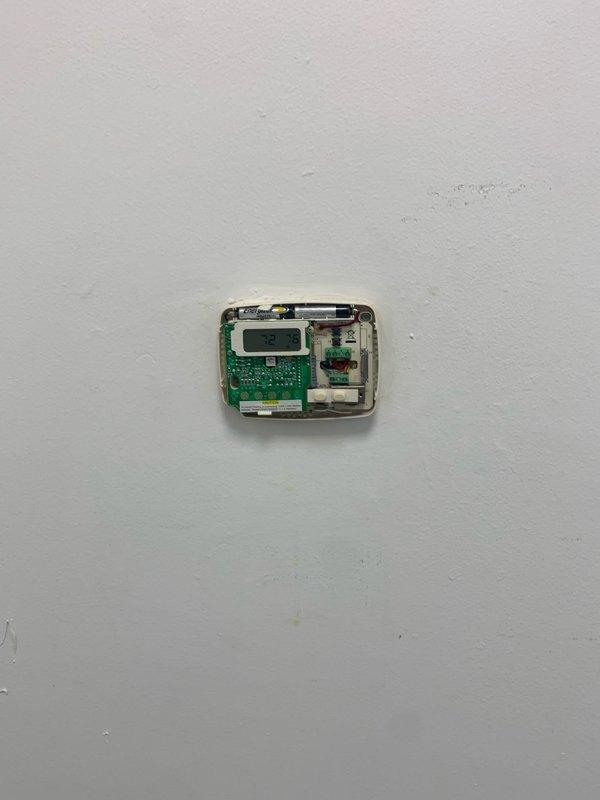 Relocated existing digital thermostat from original wall location to new position in commercial space undergoing renovation. Disconnected wiring from existing thermostat control unit, verified circuit functionality, and reinstalled device at customer-requested location. Patched and prepared original wall mounting area for finishing work.