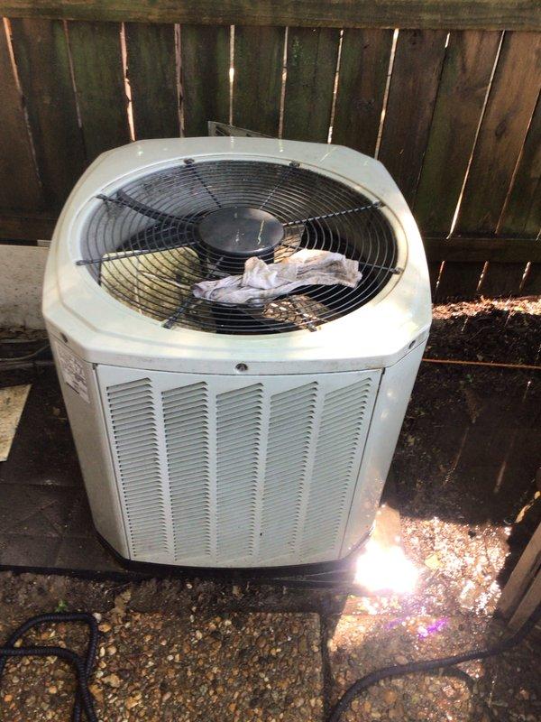 Completed cooling system tune-up on single outdoor AC unit. Inspected air filter which showed moderate dust accumulation, checked indoor air handling components with visible condensation on ductwork indicating normal operation, and examined outdoor condenser unit with fan grille and louvered panels showing minor weathering. All components operational and system running within normal parameters.