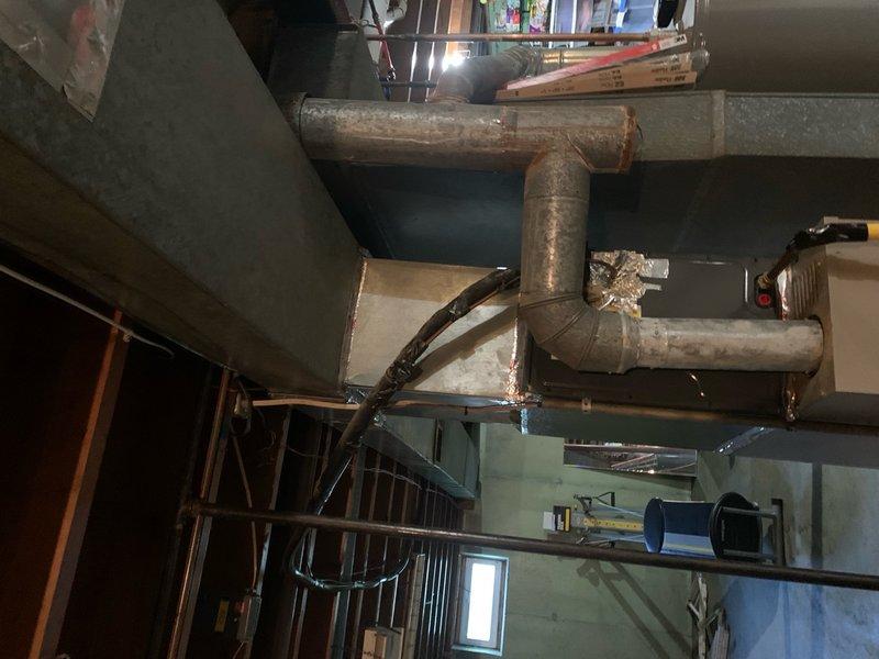 Performed diagnostic evaluation on 2-year-old HVAC system experiencing cooling deficiencies for home warranty assessment. Inspection revealed improperly installed ductwork system with significant deterioration, including extensive rust, corrosion, and weathering on metal components. Documented compromised duct connections, joints, and elbows throughout the system, along with deteriorated ceiling-mounted infrastructure showing inadequate support and installation standards. System assessment identified multiple installation deficiencies contributing to poor cooling performance, with photographic documentation provided for warranty claim processing.