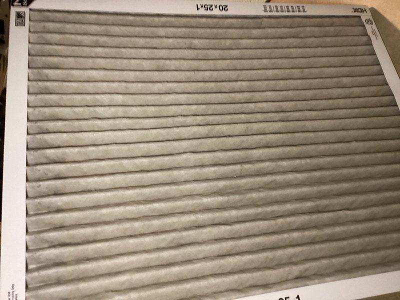 Completed comprehensive tune-up on residential air conditioning system, including inspection of control board, electrical connections, and all major components. Identified heavily soiled air filter with significant dust and debris accumulation affecting system airflow and efficiency; documented filter condition and unit's internal electrical components including control board with multiple wire connections, blower motor housing, and capacitor. System operational upon completion with recommendations provided for filter replacement to restore optimal performance.