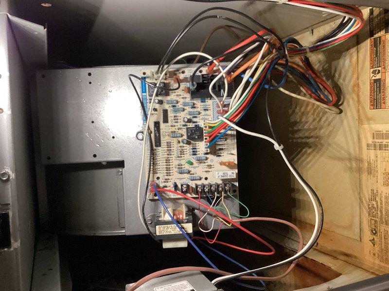 Completed comprehensive tune-up on residential air conditioning system, including inspection of control board, electrical connections, and all major components. Identified heavily soiled air filter with significant dust and debris accumulation affecting system airflow and efficiency; documented filter condition and unit's internal electrical components including control board with multiple wire connections, blower motor housing, and capacitor. System operational upon completion with recommendations provided for filter replacement to restore optimal performance.