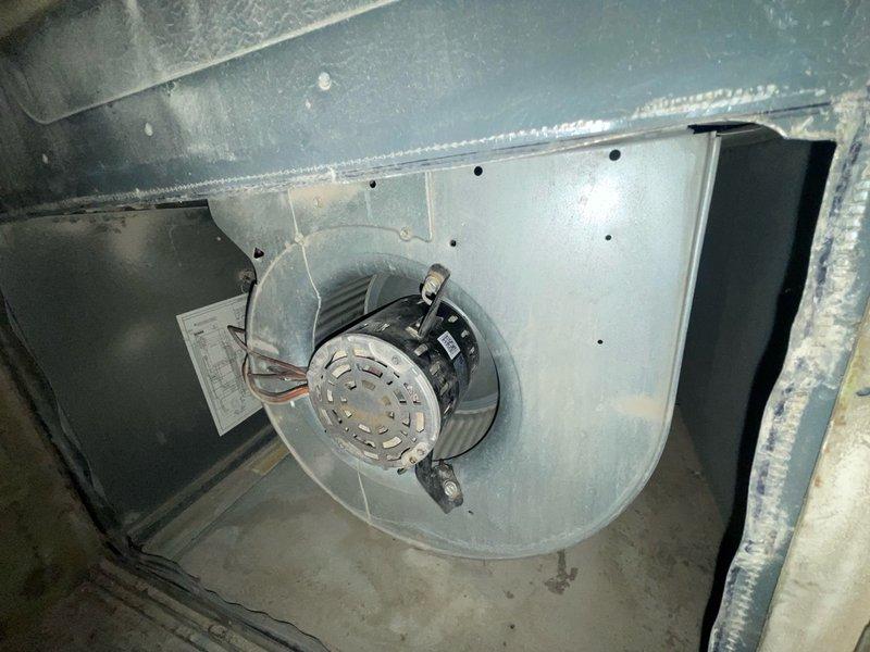 Completed comprehensive cooling system tune-up on ground-level AC unit located at rear of property. Performed standard maintenance procedures including inspection of outdoor condenser unit with louvered side panels and cylindrical fan guard, verified proper operation of indoor blower assembly and squirrel cage fan within metal ductwork plenum. All components found in satisfactory working condition with normal dust accumulation; system operating within manufacturer specifications.