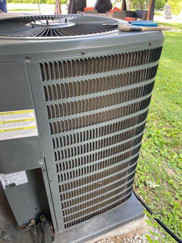 Completed comprehensive cooling system tune-up on ground-level AC unit located at rear of property. Performed standard maintenance procedures including inspection of outdoor condenser unit with louvered side panels and cylindrical fan guard, verified proper operation of indoor blower assembly and squirrel cage fan within metal ductwork plenum. All components found in satisfactory working condition with normal dust accumulation; system operating within manufacturer specifications.