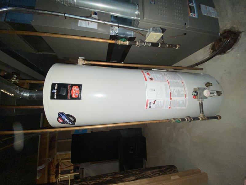 Responded to no hot water condition caused by failed water heater in 22-year-old home. Removed and disposed of existing non-functional unit. Installed new 50-gallon gas tall water heater with proper venting and gas line connections. Connected copper supply lines with brass fittings and installed temperature and pressure relief valve with discharge piping per code requirements. Obtained required water heater permit and completed installation to local plumbing standards. Tested all connections for leaks, verified proper gas combustion, and confirmed hot water delivery to fixtures throughout home. Unit operational and system restored to full functionality.