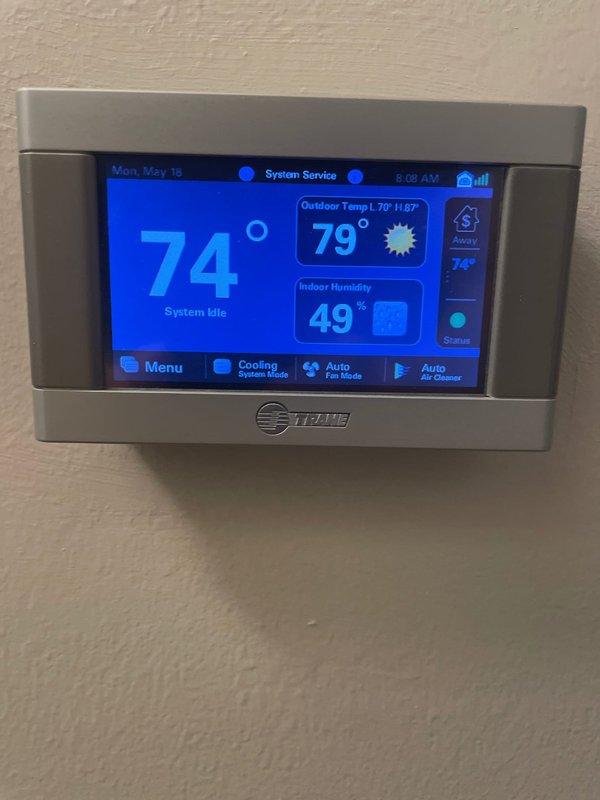 Completed annual cooling maintenance on a 9-year-old Trane AC system. Performed comprehensive tune-up including system inspection, verified thermostat operation displaying 74° setpoint with system idle status and proper humidity readings at 49%. Inspected and documented FILTERBUY pleated air filter showing good condition with clean media. All components operating within normal parameters, system functioning properly with no issues identified.