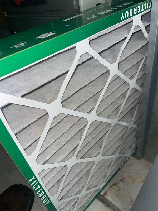 Completed annual cooling maintenance on a 9-year-old Trane AC system. Performed comprehensive tune-up including system inspection, verified thermostat operation displaying 74° setpoint with system idle status and proper humidity readings at 49%. Inspected and documented FILTERBUY pleated air filter showing good condition with clean media. All components operating within normal parameters, system functioning properly with no issues identified.