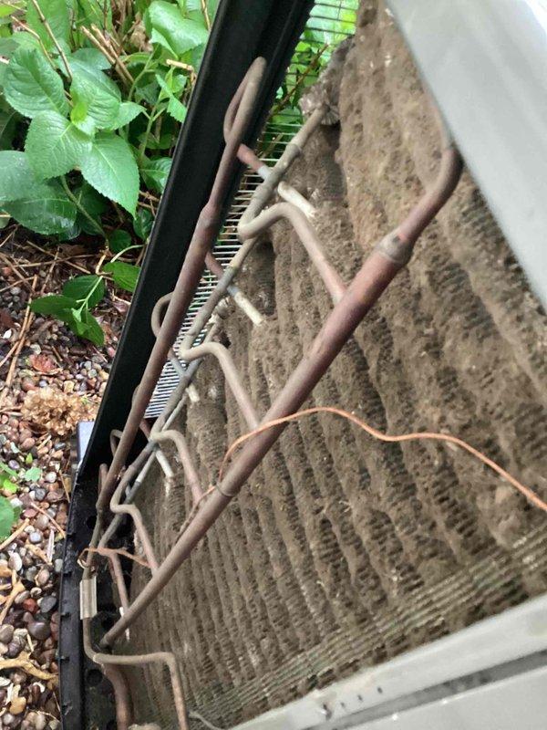Responded to no cooling call on 4-year-old ground-level system displaying error codes 184.07 and 24.08 with complete unit failure. Upon arrival, found outdoor condenser coil heavily caked with dirt, dust, and debris causing significant airflow restriction and impaired heat exchange capability. Performed thorough coil cleaning to restore proper airflow and system operation. Inspected indoor air return grille and verified adequate airflow at air handler. Cleared fault codes, cycled system through complete operational test, and confirmed unit returned to normal cooling operation with proper temperature differential across coil.