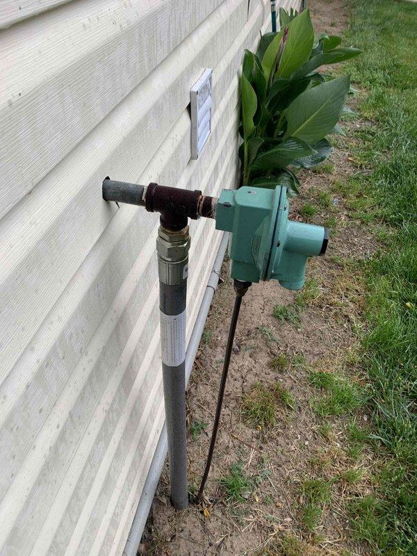 Returned to site to inspect electrical meter in coordination with Metro Electric. Documented existing outdoor electrical infrastructure including residential standby generator installation with associated gas supply line, shut-off valve, sediment trap, and conduit connections. Photographed generator unit mounted on concrete pad with proper ventilation and safety components, as well as exterior utility connections and piping configurations for service records.