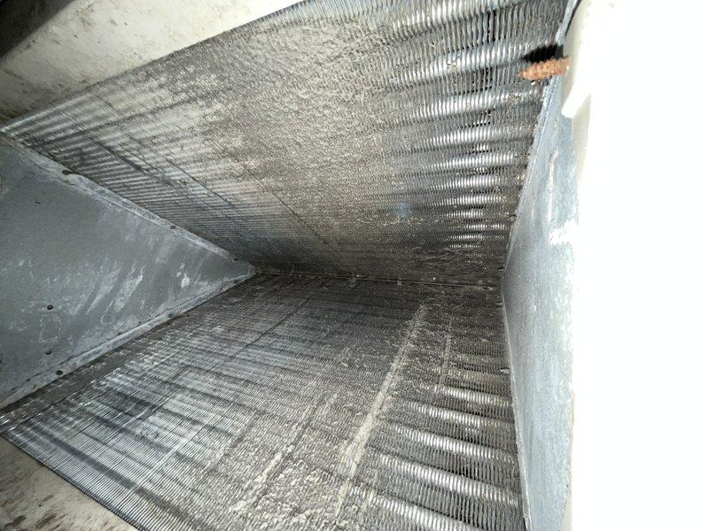 Responded to no cooling call for commercial property with 13-year-old Coleman unit blowing warm air throughout building. Upon inspection, found evaporator coil heavily restricted with dust, lint, and debris accumulation, severely limiting airflow and heat transfer capacity. Accessed blower compartment and electrical components, which showed signs of age and dust buildup. Cleaned evaporator coil thoroughly to restore proper airflow, inspected blower motor and electrical connections for proper operation, and verified all contactors and circuit breakers functioning correctly. System restored to normal cooling operation with adequate airflow and temperature differential. Recommended regular filter changes and periodic coil cleaning to prevent future airflow restrictions.