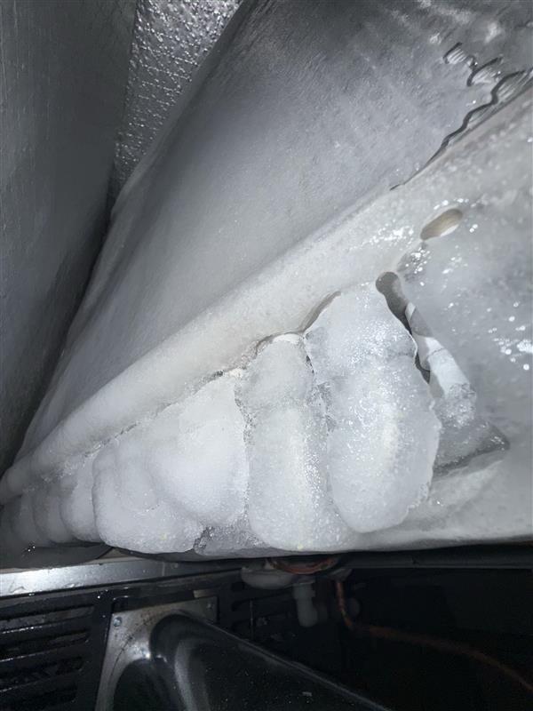 Responded to no-cool call on residential split system less than 10 years old. Upon arrival, found evaporator coil completely frozen with severe ice buildup throughout the indoor unit. Diagnosed restricted airflow as primary cause of freezing condition. Shut down system to allow complete defrost of coil. Inspected outdoor condensing unit and verified proper operation of compressor and condenser fan. Checked refrigerant lines and connections for proper insulation and signs of restriction. System unable to maintain setpoint temperature due to ice blockage preventing proper heat exchange. Allowed adequate defrost time before further diagnostics to determine underlying cause of airflow restriction, which may include dirty filter, blocked return air, low refrigerant charge, or blower motor issues requiring follow-up service.