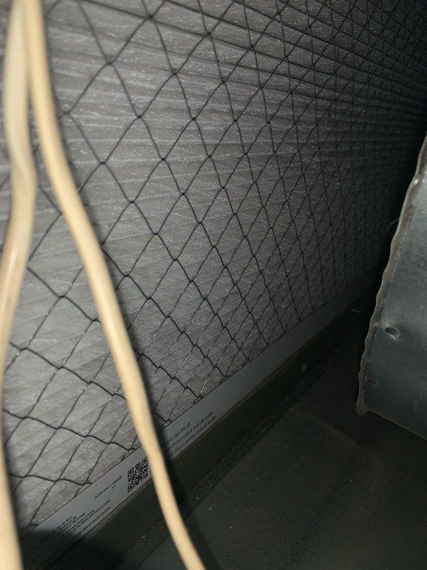 Completed comprehensive cooling system tune-up on 8-year-old outdoor AC unit. Performed thorough cleaning of condenser coil which had significant debris accumulation including leaves, dirt, and organic matter that was restricting airflow and reducing system efficiency. Inspected evaporator coil and air filtration components, noting diamond-pattern filter in acceptable condition. Checked refrigerant lines and connections for proper insulation and signs of wear. Provided quote for thermostat replacement as requested. System operational and running efficiently following maintenance.