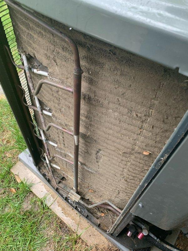 Completed comprehensive cooling system tune-up on 8-year-old outdoor AC unit. Performed thorough cleaning of condenser coil which had significant debris accumulation including leaves, dirt, and organic matter that was restricting airflow and reducing system efficiency. Inspected evaporator coil and air filtration components, noting diamond-pattern filter in acceptable condition. Checked refrigerant lines and connections for proper insulation and signs of wear. Provided quote for thermostat replacement as requested. System operational and running efficiently following maintenance.