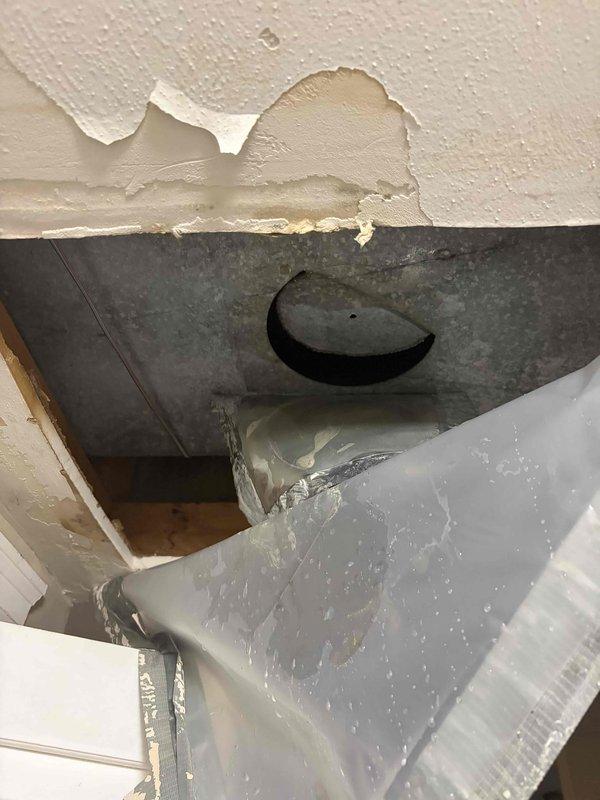 # HVAC Service Completed

Responded to service call for furnace leaking when air conditioning system operates. Upon arrival, inspected 10-year-old air handler unit located in first-floor utility closet. Found evidence of significant water damage to ceiling above unit, with peeling paint and exposed substrate indicating ongoing moisture intrusion. 

Investigation revealed condensate drainage issue from air handler causing water to overflow and damage surrounding structure. Inspected condensate drain line, drain pan, and associated plumbing connections. Cleared blockage in condensate line that was preventing proper drainage during cooling operation. Verified drain pan integrity and confirmed proper pitch for water flow.

Tested system operation in cooling mode to ensure condensate drains properly without overflow. Monitored unit through complete cooling cycle to verify repair effectiveness. Checked air filter condition and confirmed adequate airflow through system. Documented existing ce