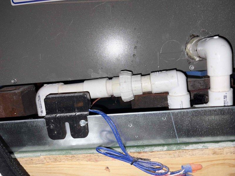Responded to callback for attic-mounted HVAC unit with clogged condensate drain line. Cleared blockage from drain pipe to restore proper water drainage from system. Verified condensate pump operation and confirmed all electrical connections secure. System tested and operating normally with proper drainage flow restored.