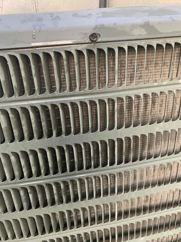Completed cooling system tune-up and preventative maintenance on 16-year-old outdoor condenser unit. Performed comprehensive inspection of heat exchanger coils, which showed moderate dirt and debris accumulation between aluminum fins requiring attention. Evaluated overall unit operation, checked refrigerant levels, tested electrical connections, inspected fan motor and blade assembly, and verified proper airflow through ventilation slats. Unit operational upon completion with recommendations provided for ongoing maintenance to ensure optimal efficiency.