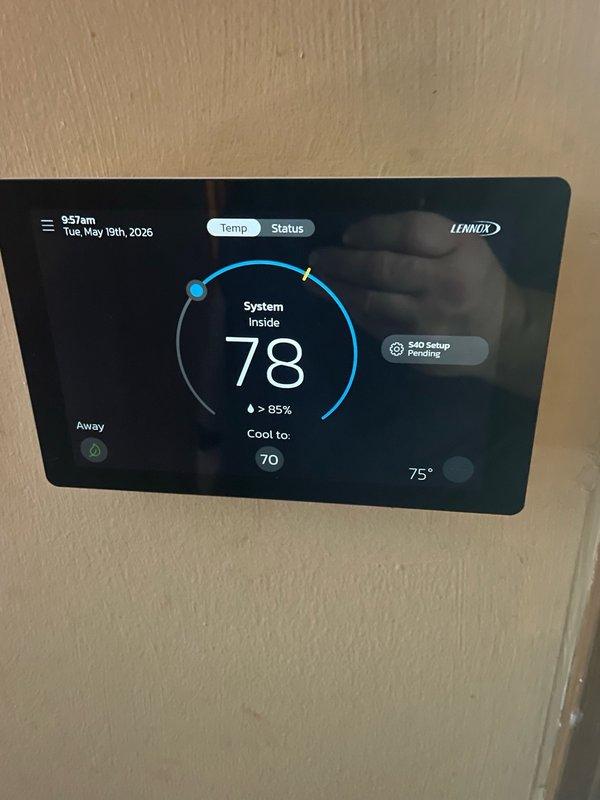 Responded to no cooling complaint on 3-year-old Lennox system with urgent light illuminated on thermostat panel. Found S40 thermostat displaying "Setup Pending" status with system not responding to cooling calls despite 78°F indoor temperature against 70°F setpoint. Removed thermostat from wall mount, accessed internal circuit board, and completed system configuration setup that was left incomplete following previous service visit. Verified thermostat communication with HVAC unit, cleared urgent status indicator, confirmed cooling cycle initiation, and restored normal system operation with proper temperature control functionality.