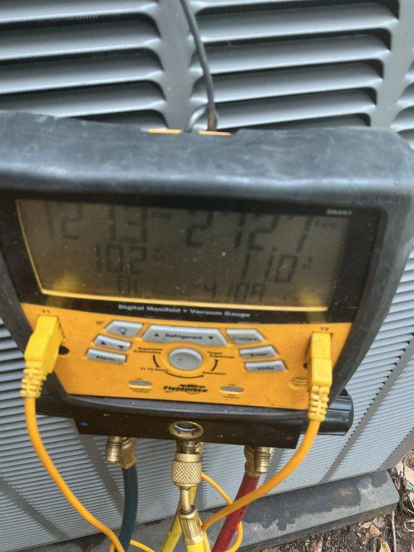Responded to no cooling complaint with reported refrigerant leak. Upon arrival, accessed indoor unit compartment and inspected electrical connections and wiring harness. Connected Fieldpiece digital manifold gauges to outdoor condensing unit service ports to evaluate system pressures and diagnose refrigerant circuit performance. Measured operating pressures on both high and low sides using calibrated gauges with standard refrigerant hoses. Based on pressure readings and visual inspection, confirmed refrigerant system issue affecting cooling capacity. Documented equipment condition and diagnostic findings with photographic evidence for service records.