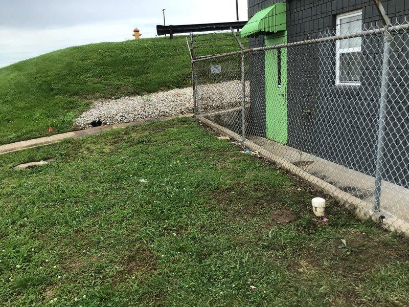 Responded to commercial property for main drain stoppage. Located cleanout access point in exterior area near chain-link fence line. Successfully cabled main drain line to clear obstruction and restore proper flow. Tested system to confirm drainage restored to normal operation. Photographed work area and cleanout location for service documentation.
