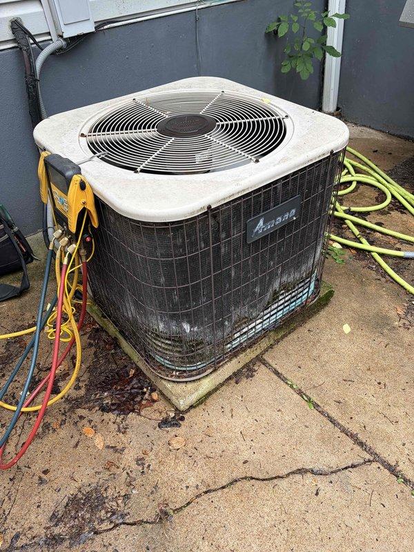 Responded to service call for 22-year-old Amana air conditioning system with reported noise coming from outdoor condensing unit during operation. Performed diagnostic testing on the condenser unit using clamp meter to measure electrical amperage draw, recording 186.8 amps during testing sequence. Connected manifold gauges with refrigerant hoses to system to evaluate operating pressures and assess compressor performance. Inspected condenser coils, fan motor operation, and electrical connections on outdoor unit to identify source of abnormal noise and determine necessary repairs for proper system function.