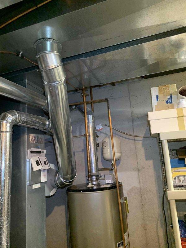 Successfully installed a 50-gallon tall gas water heater in basement utility room. Removed existing unit and installed new tank with proper venting through stainless steel exhaust flue system connected to ceiling. Installed 3/4-inch pressure reducing valve (PRV) as part of the installation to regulate incoming water pressure. Connected all copper supply and discharge lines, ensuring proper hot and cold water integration with existing plumbing infrastructure. Verified all gas connections for safety and proper operation. Tested unit for leaks, proper ignition, and temperature regulation. Installation completed in compliance with local building codes; no permit required per municipal regulations. Unit is fully operational and ready for service.