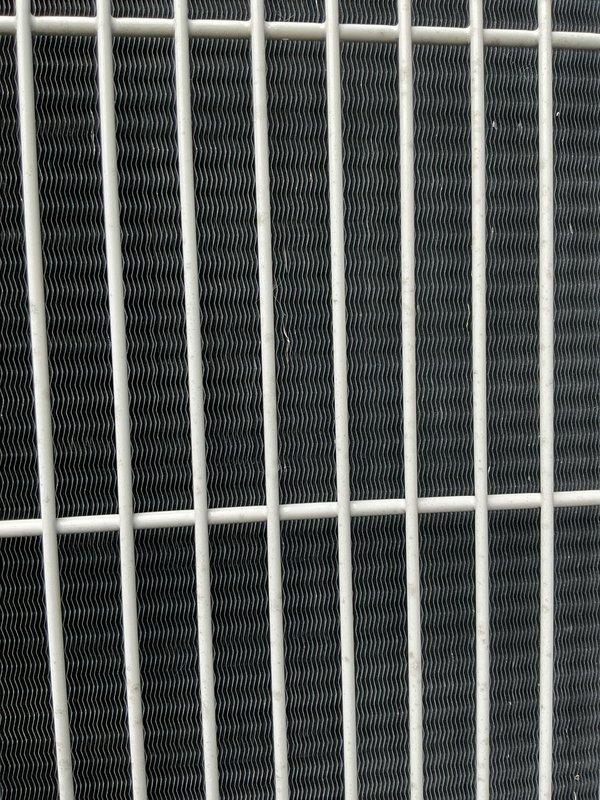 Completed preventive maintenance tune-up on outdoor condensing unit for Home Depot work order F58668204. Performed comprehensive system inspection, finding unit in good operating condition with clean coils and no accessories requiring attention. Documented equipment condition with photographs showing heat exchanger fins free of debris and proper airflow through protective grille.