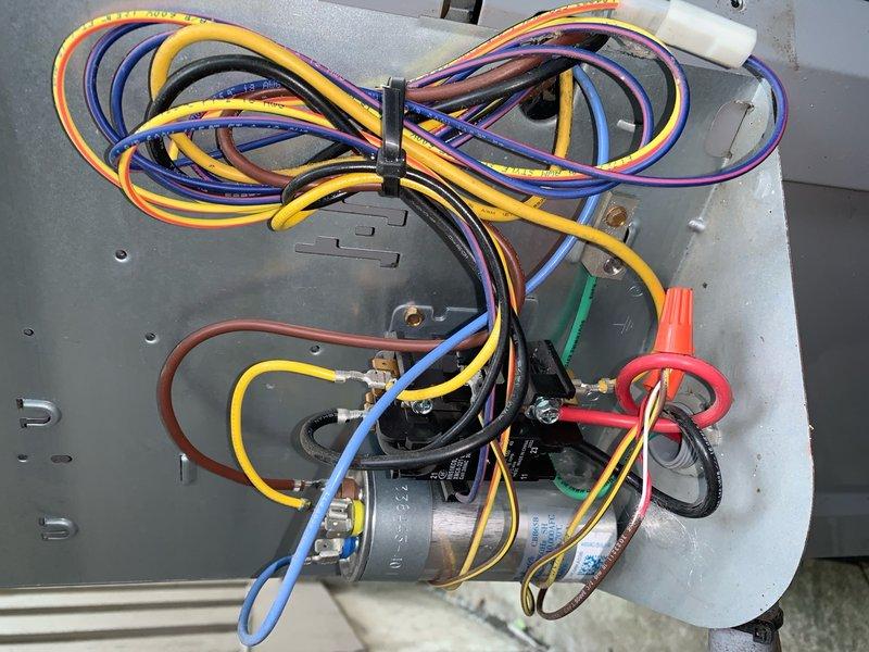Completed comprehensive tune-up service on a 5-year-old residential air conditioning unit located at ground level. Performed standard preventive maintenance protocol including inspection of blower assembly, capacitor, and electrical connections. Verified all wiring harnesses were properly secured and electrical components were functioning within specifications, with particular attention to the capacitor and associated control wiring.