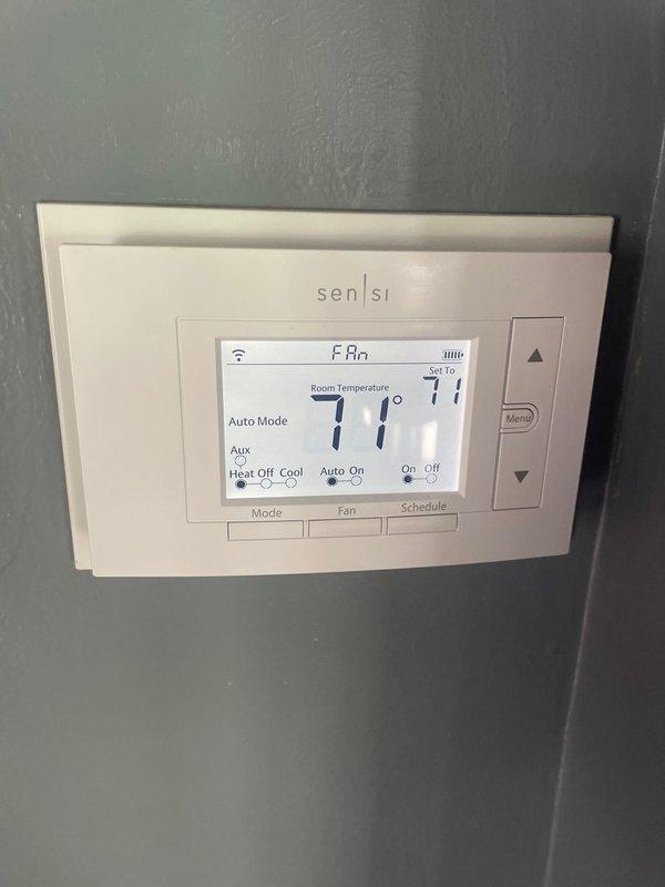 Completed cooling season tune-up on 2-year-old heat pump system. Performed comprehensive maintenance including inspection of outdoor condenser unit, verified proper refrigerant levels, cleaned condenser coils showing minor dirt accumulation, checked electrical connections, and tested system operation. Confirmed Sensi thermostat functioning correctly in auto mode at 77°F setpoint with proper communication to heat pump unit. System operating within manufacturer specifications with no repairs required at this time.