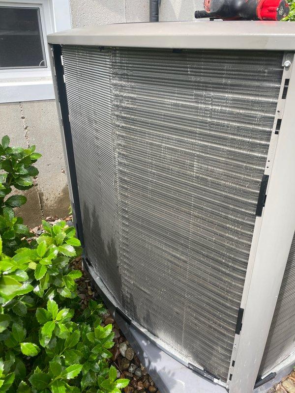 Completed cooling season tune-up on 2-year-old heat pump system. Performed comprehensive maintenance including inspection of outdoor condenser unit, verified proper refrigerant levels, cleaned condenser coils showing minor dirt accumulation, checked electrical connections, and tested system operation. Confirmed Sensi thermostat functioning correctly in auto mode at 77°F setpoint with proper communication to heat pump unit. System operating within manufacturer specifications with no repairs required at this time.