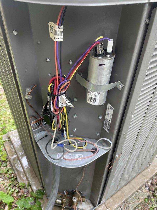 Completed comprehensive cooling tune-up maintenance on two HVAC units for new customer. Both units are approximately one year old, with one ground-mounted outdoor condenser and one basement-located unit. Performed standard U10 cooling system inspection protocol on both systems, including electrical component testing, capacitor evaluation, refrigerant pressure checks, and airflow assessment. Outdoor unit exhibited heavy dirt and debris accumulation on condenser coils and louvered panels, which was documented. All electrical connections, wiring, and mounted components were inspected and found to be properly secured and functional despite outdoor exposure conditions.