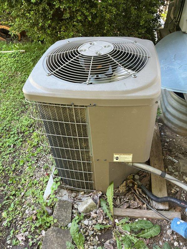 Responded to no cooling complaint on 10-year-old residential air conditioning system. Upon arrival, performed diagnostic evaluation of outdoor condenser unit located in backyard and indoor air handler in attic space. Inspected refrigerant lines, electrical connections, and system components. Documented equipment condition with photos showing condenser unit with protective grille, air handler with foil-faced insulation, flexible ductwork, and refrigerant line set with service ports. System evaluated for proper operation and potential causes of cooling failure.