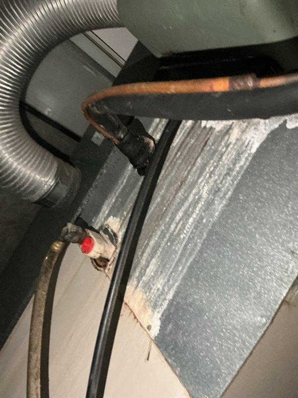 Responded to no cooling complaint on 10-year-old residential air conditioning system. Upon arrival, performed diagnostic evaluation of outdoor condenser unit located in backyard and indoor air handler in attic space. Inspected refrigerant lines, electrical connections, and system components. Documented equipment condition with photos showing condenser unit with protective grille, air handler with foil-faced insulation, flexible ductwork, and refrigerant line set with service ports. System evaluated for proper operation and potential causes of cooling failure.