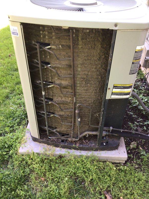 Completed seasonal tune-up maintenance on residential outdoor condensing unit. Upon arrival, found evaporator coil heavily clogged with dirt, dust, and debris significantly restricting airflow through the system. Performed electrical diagnostics using multimeter, obtaining voltage reading of 305V at capacitor terminals. Tested capacitor functionality and verified proper electrical connections throughout the unit. Removed front access panel to expose internal coil assembly for thorough inspection and cleaning. Addressed substantial accumulation of outdoor contaminants on aluminum fin structure to restore proper system airflow and efficiency. All electrical components tested within normal operating parameters upon completion of maintenance service.