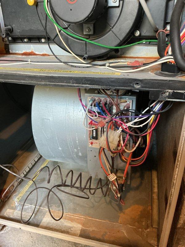 Completed comprehensive cooling season tune-up on 22-year-old Amana air conditioning system. Performed full system inspection including blower motor assembly, electrical connections, and outdoor condenser unit. Verified all wiring connections at junction box, inspected blower housing and motor operation, and evaluated outdoor unit condition including fan operation and coil accessibility. System operating within normal parameters upon completion of maintenance service.