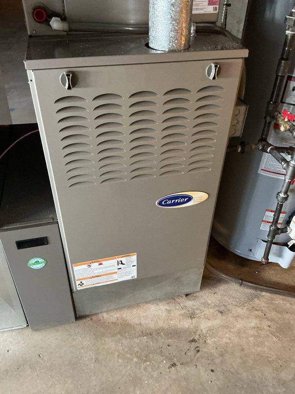 Responded to service call for water leaking from condensate drain on 9-year-old residential air conditioning system. Upon arrival, inspected outdoor condenser unit and indoor Carrier furnace with cooling coil. Found condensate drain line clogged, causing water backup and overflow. Cleared blockage from drain line using appropriate methods, verified proper drainage flow, and tested system operation. Checked refrigerant levels, electrical connections, and overall system performance to ensure proper functioning. Customer advised that clogged drain was likely contributing to water waste and elevated water bill. System now operating normally with condensate draining properly.