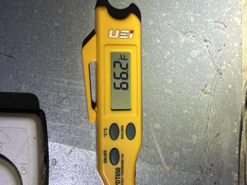 Performed diagnostic evaluation on 10-year-old geothermal system located in basement. Accessed electrical control panel and inspected internal components including circuit breakers, wiring connections, and motor assembly. Measured and documented system temperatures using calibrated digital thermometer, recording 66.2°F reading at floor level. Inspected electrical connections, capacitor, and control circuitry for proper operation and signs of wear or failure.