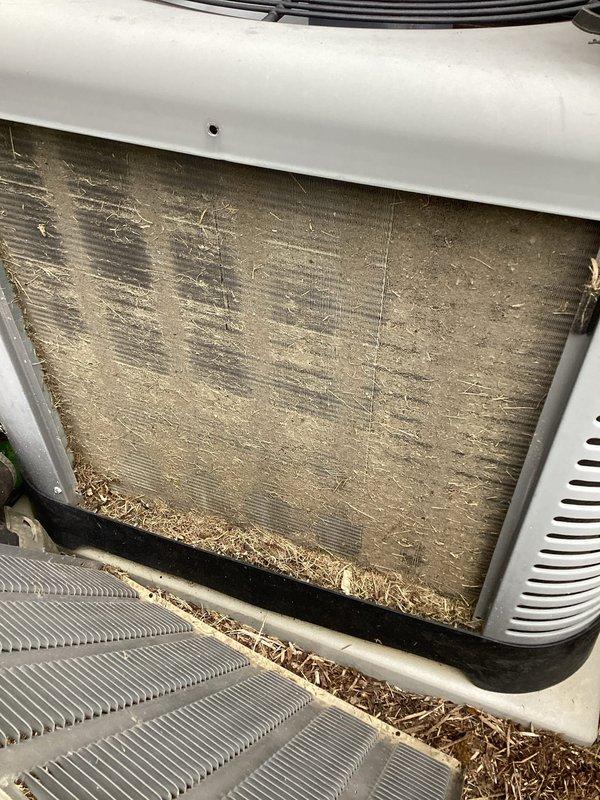 Responded to service call for 5-year-old Ruud system displaying "seek service" error and inadequate cooling. Upon inspection, discovered severely clogged air filter and condenser coil heavily contaminated with dust, dirt, and organic debris including leaves and plant matter. Removed and replaced dirty filter, thoroughly cleaned condenser coil fins and interior components, and cleared all debris from unit base and intake areas. Verified proper airflow restoration, cleared thermostat error code, and tested system operation to confirm full cooling capacity restored.